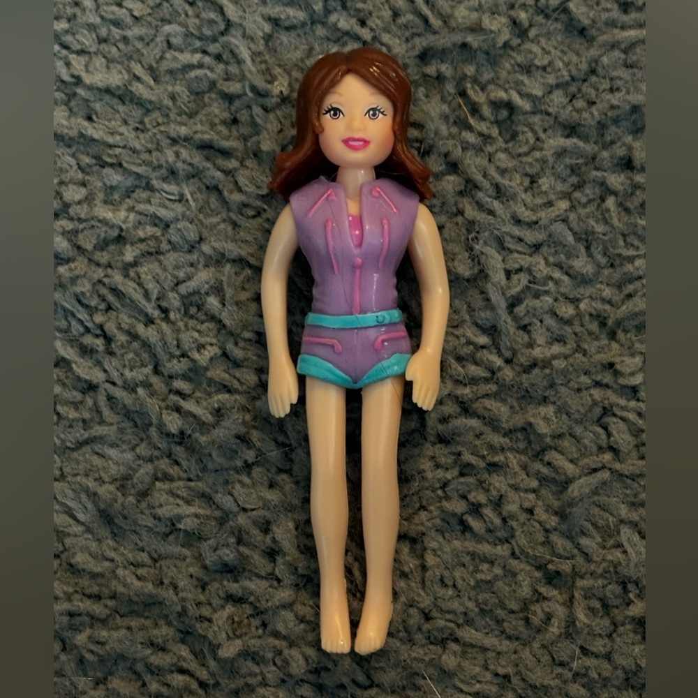 Lightly used Polly Pocket with brown hair and a purple safari outfit